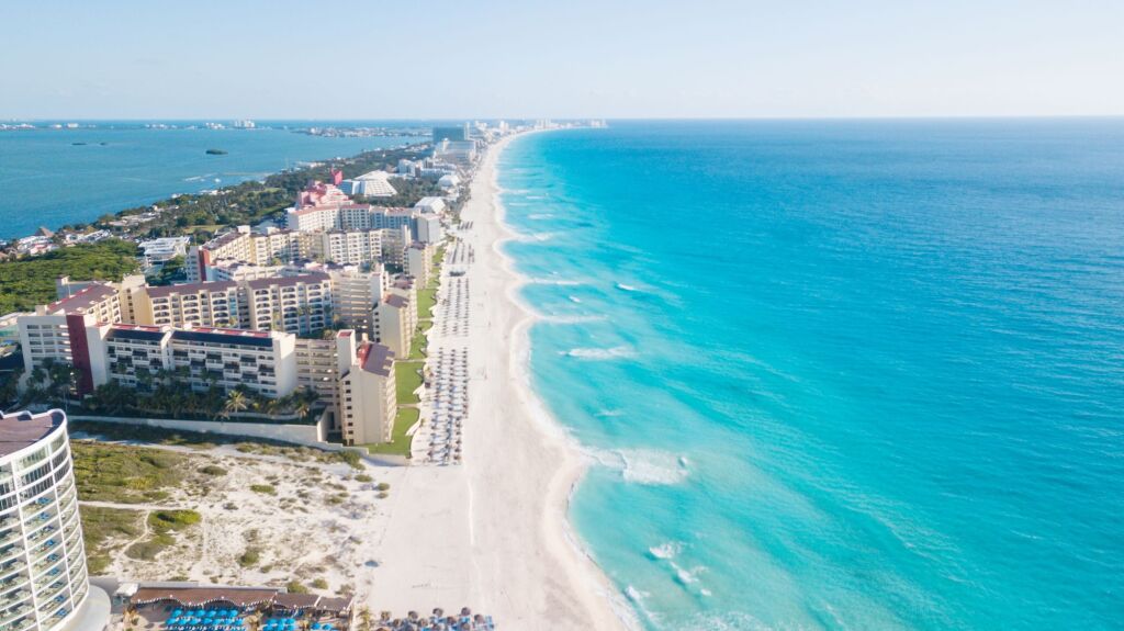 Cancun beach panorama aerial view. Zona hotelera top view. Caribbean seaside beach with turquoise water and big wave