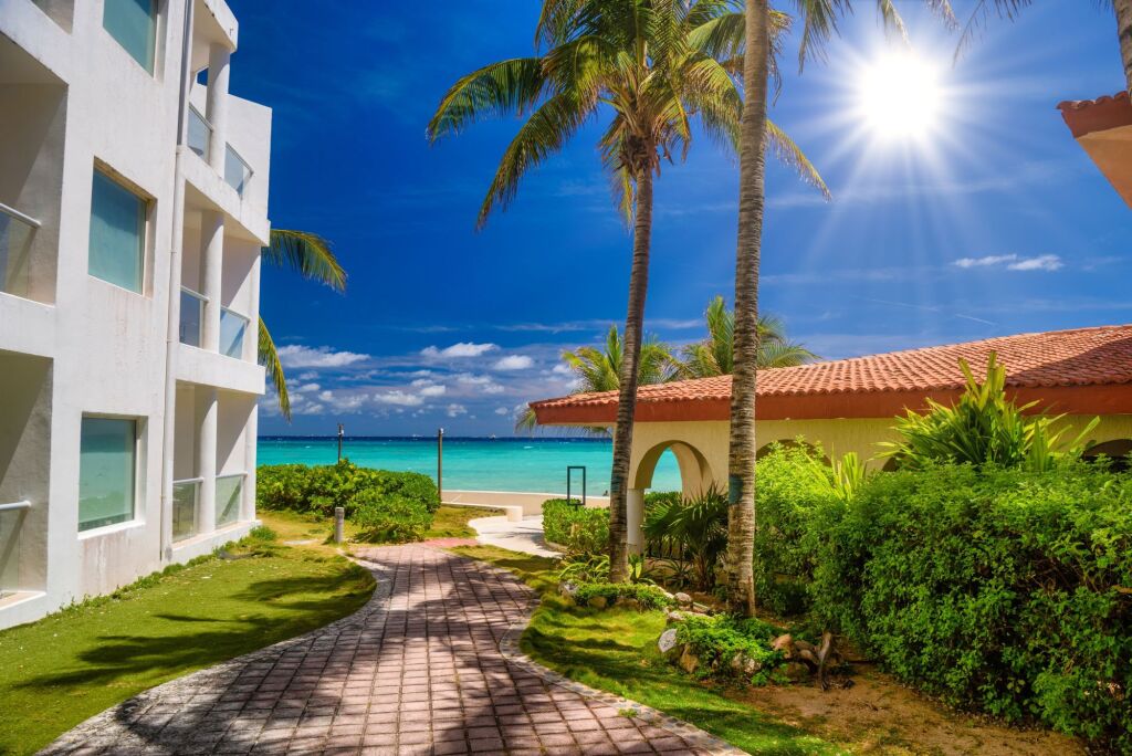Luxury white villa with palms in Playa del Carmen, Yukatan, Mexico.
