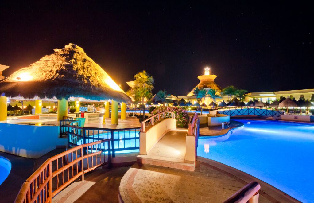 Swimming pool at a luxury caribbean, mexican resort at night, dawn time.