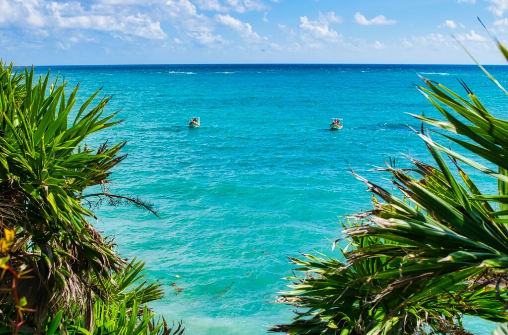 The sea at Tulum Mexico. December 2021. This was during a hot day during the Covid 19 pandemic. The Beautiful blue sky contrasts against the turquoise Caribbean sea. 