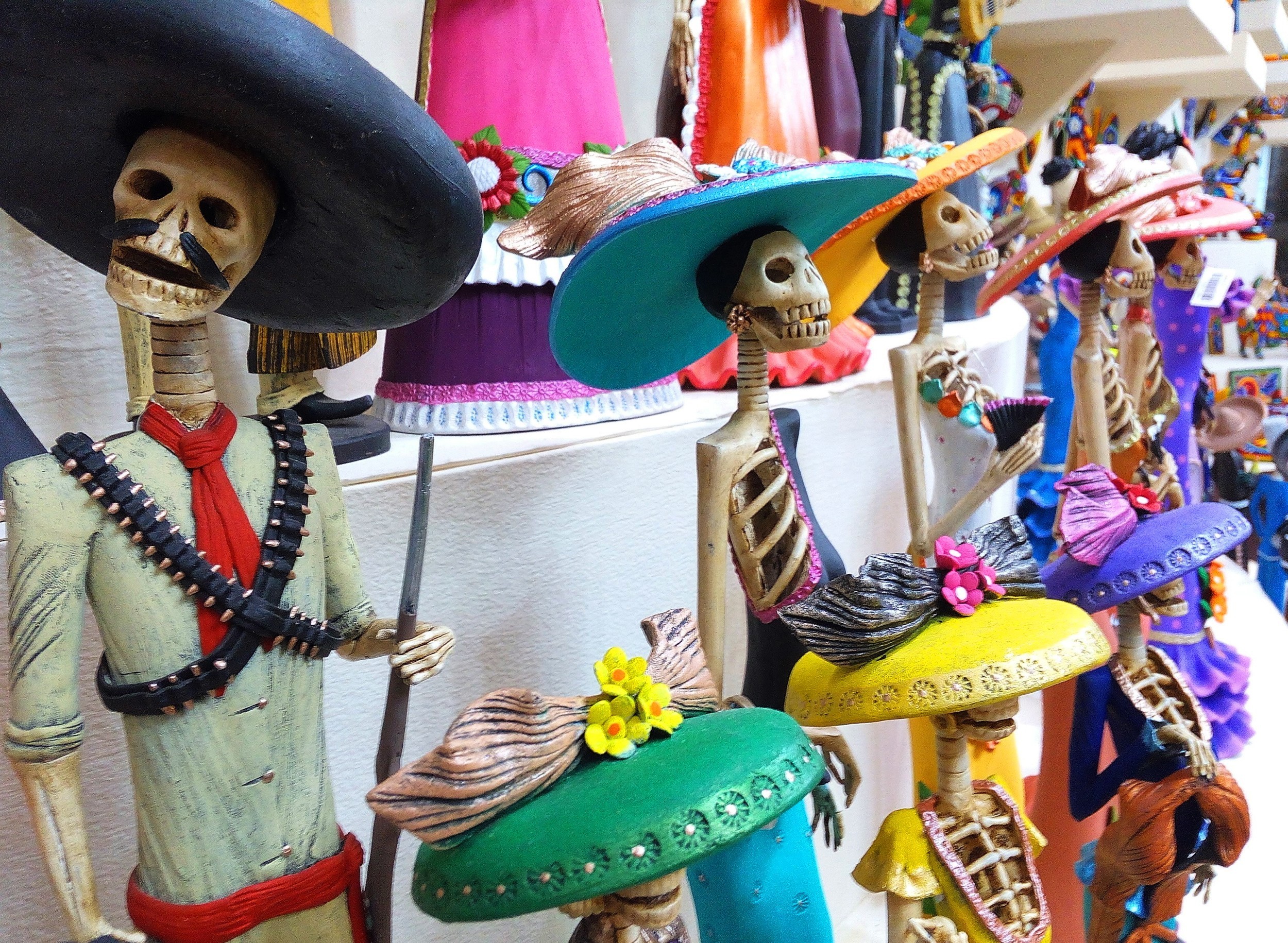 Traditional Mexican skulls (Calaveras), skeletons, La Muerte masks and other scary / death symbols of the Day of the Dead / Dia de los Muertos / Halloween, popular souvenirs sold in Mexico