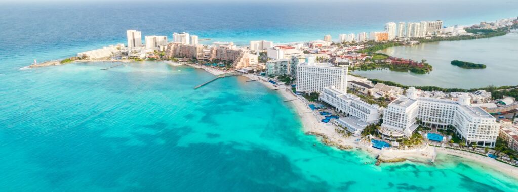 Aerial panoramic view of Cancun beach and city hotel zone in Mexico. Caribbean coast landscape of Mexican resort with beach Playa Caracol and Kukulcan road. Riviera Maya in Quintana roo region on