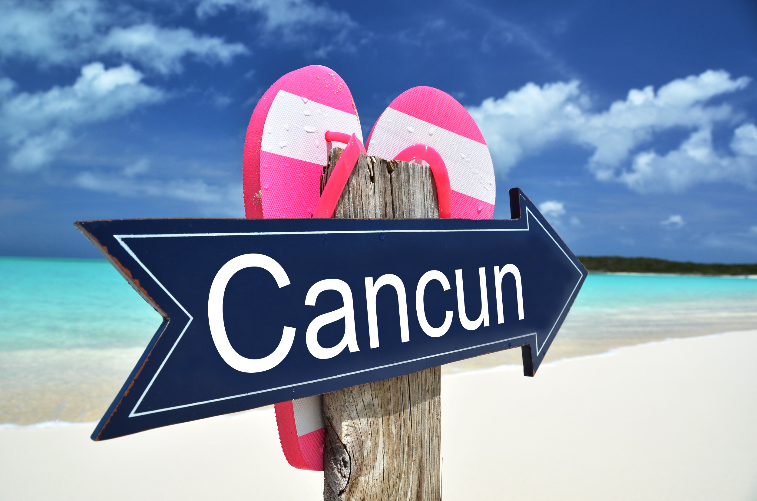 CANCUN sign on the beach
