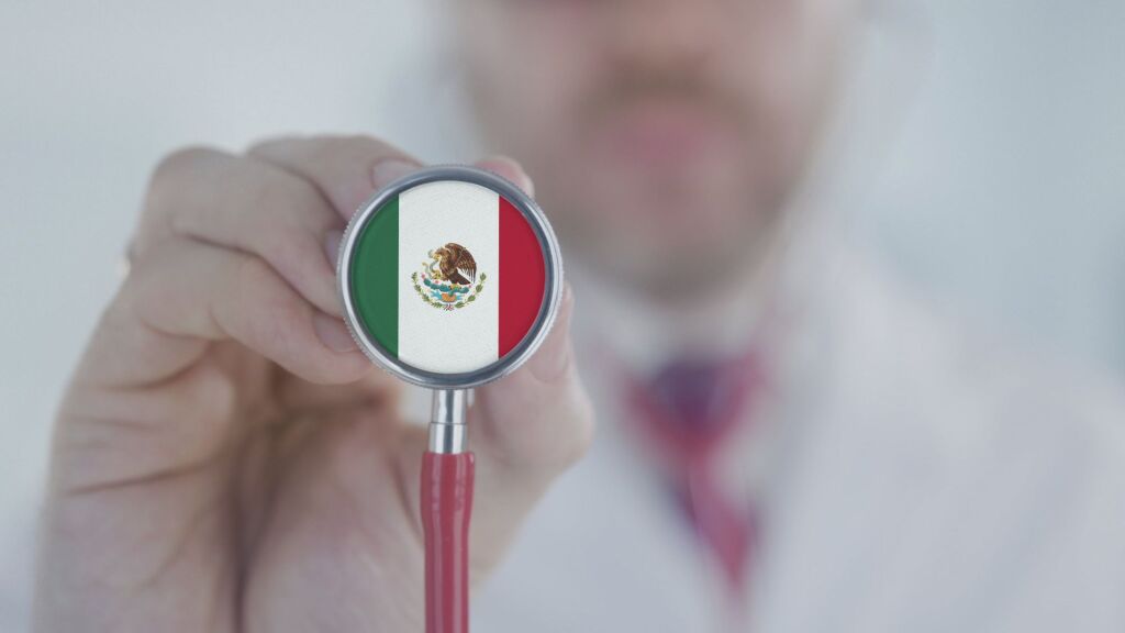 Doctor holds stethoscope bell with the Mexican flag. Healthcare in Mexico