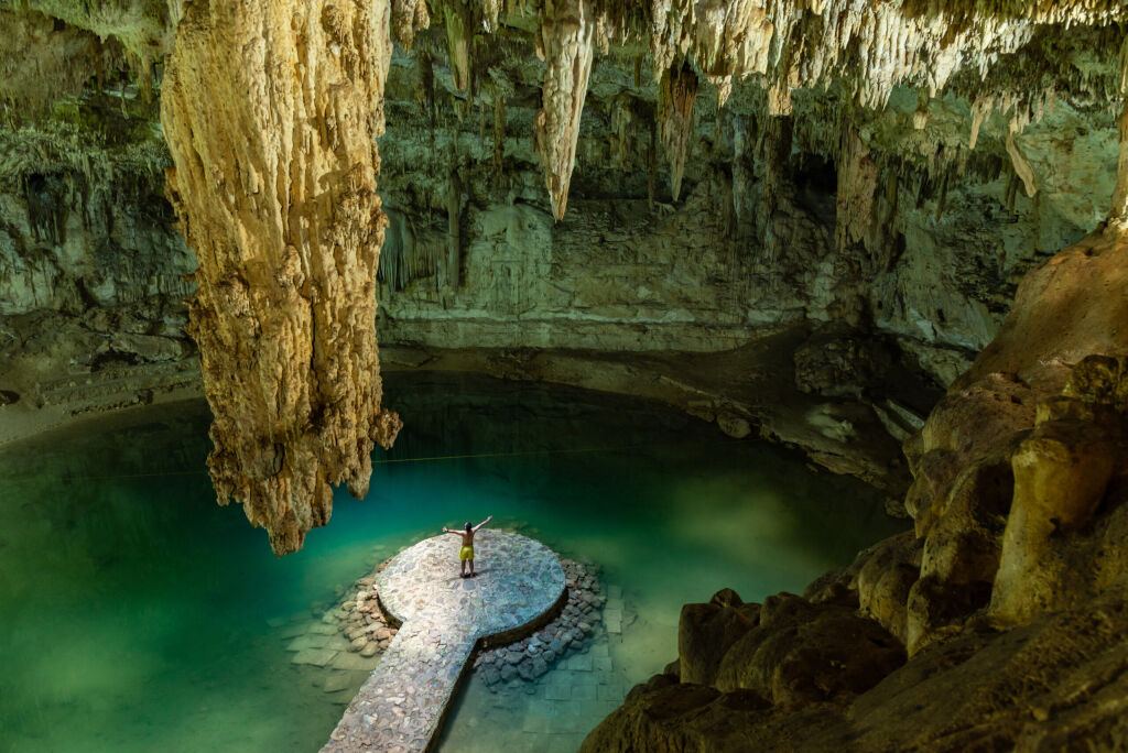 Man enjoying the view of Suytun Cenote from the top Yucatan Mexico North America