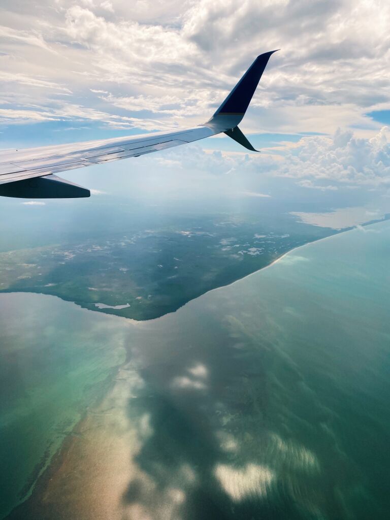 Plane Flying Over the Ocean in Mexico