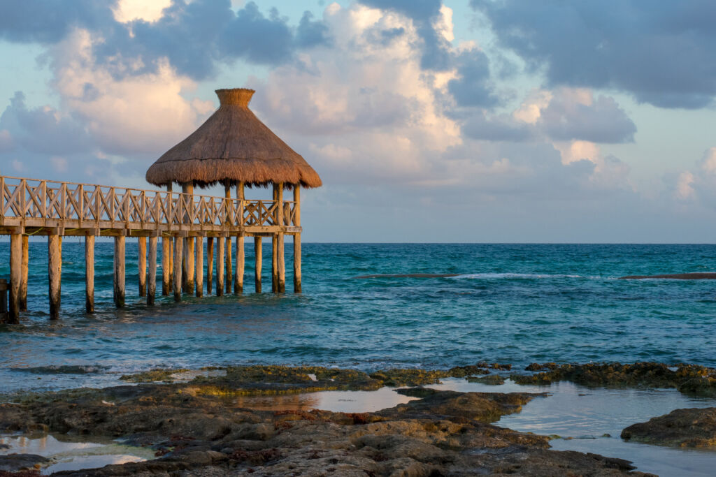 Sunset over the Caribbean Ocean from Playa del Carmen, Mexico in autumn, with a wooden pier