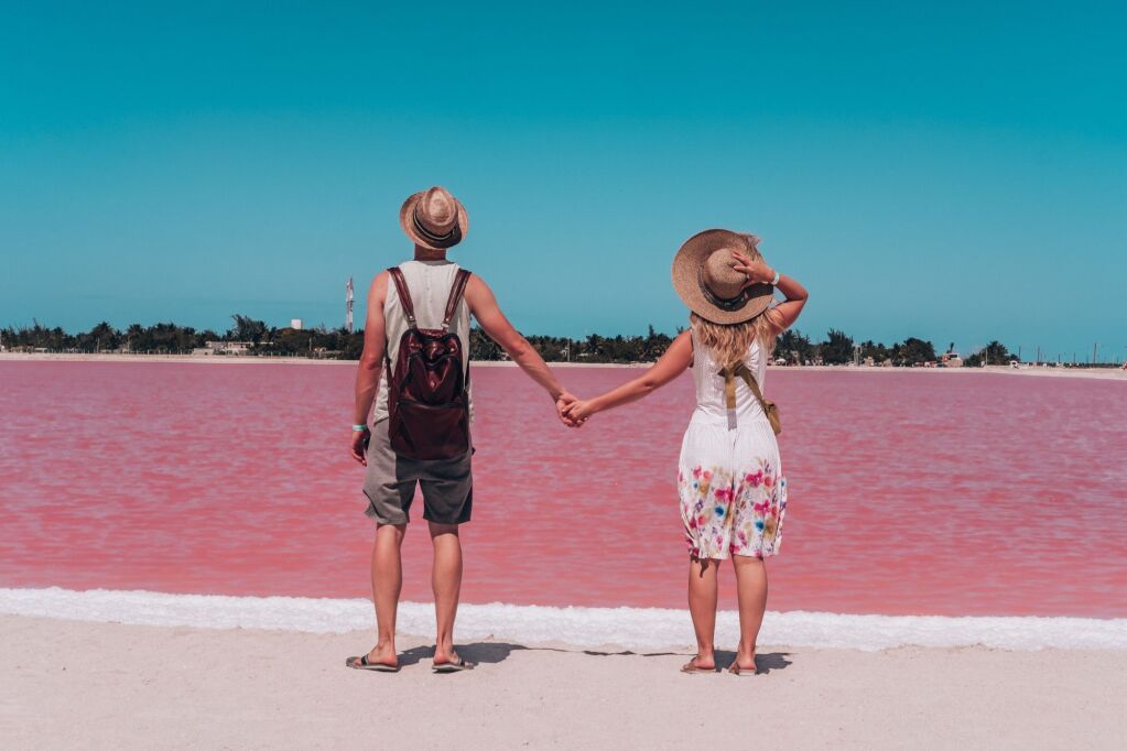 Young couple enjoying the view on the pink lakes in Mexico. Las Coloradas, Yucatan. Mexican vacation. Best things to visit in Yucatan Peninsula.