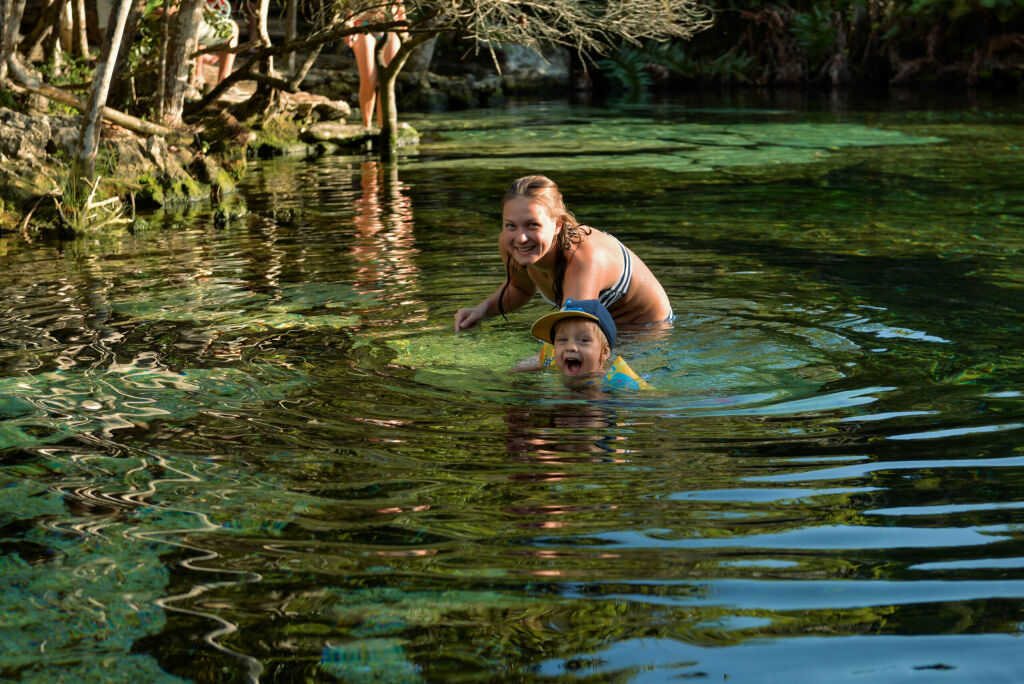 Mom and a boy swiming in the Azul cenote, Akumal, Quintana Roo, Mexico