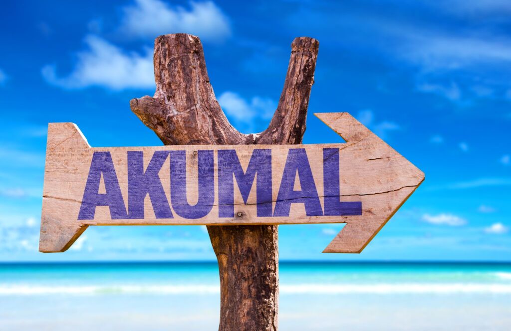 Akumal wooden sign with beach background