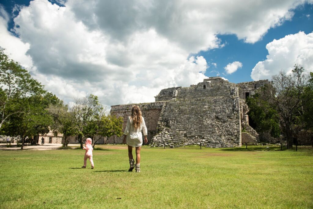 Mother and her little daughter in Chichen Itza. Mayan pyramid in Yucatan, Mexico. 