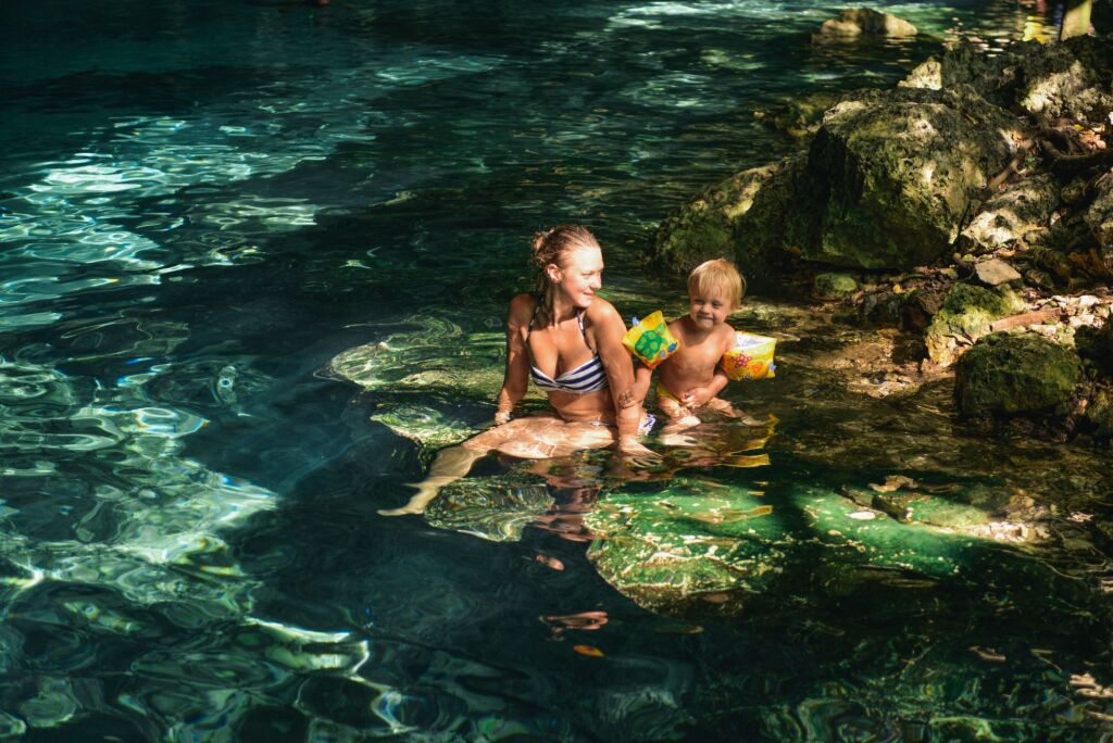 Mom and a boy in the Dos Ojos cenote, Tulum, Quintana Roo, Mexico